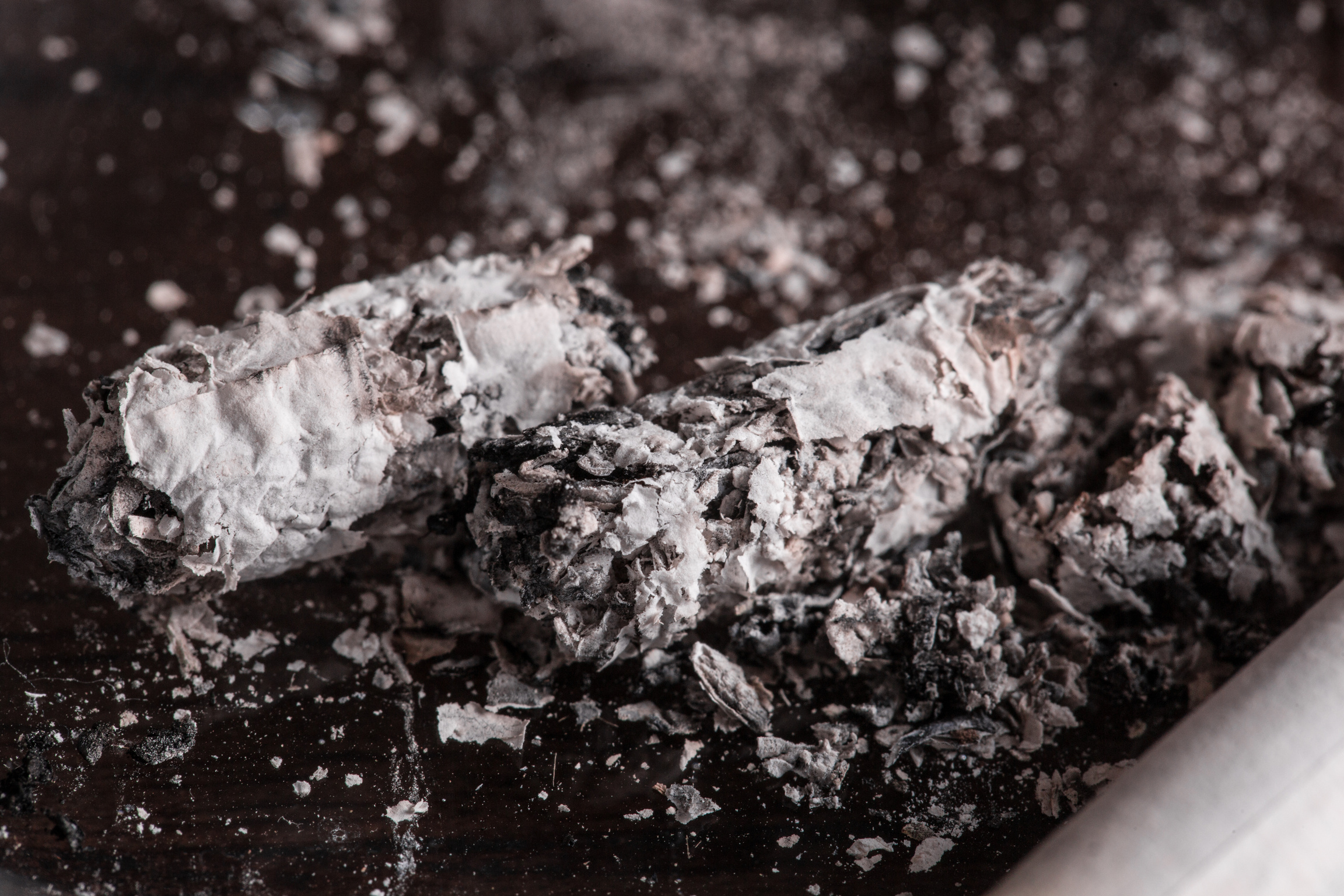 Burning cigarette ashes on an ashtray